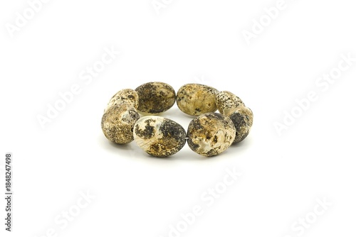 Handmade bracelet crafted from Baltic chalk amber stones, studio shot on white background