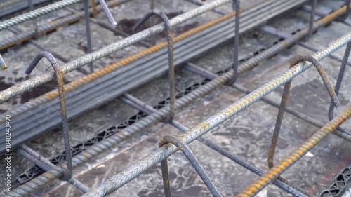 A close-up video capture showcases steel rebars, iron reinforcement for slab construction.