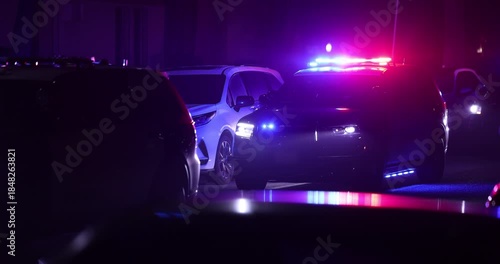 Illuminated night view of police units on a city street.