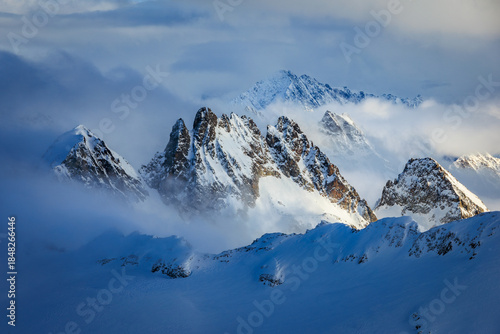 Snowy Spannort peaks seen through clouds at Mount Titlis, Engelberg, Switzerland