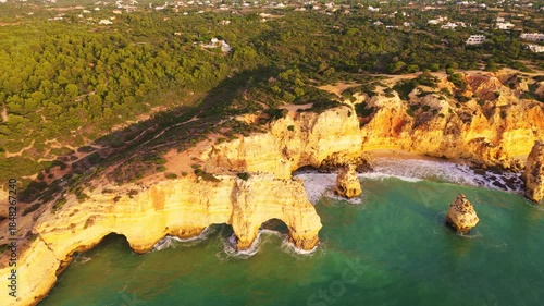 Marinha Beach, Arch, Sea Stacks, Cliffs and Atlantic Ocean on Sunny Day. Drone Shot. Algarve, Portugal. Moving Sideways