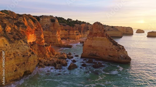 Marinha Beach, Sea Stacks, Cliffs and Atlantic Ocean at Sunrise. Golden Hour. Drone Shot. Algarve, Portugal. Moving Forward