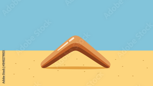Boomerang on sandy beach with blue sky representing Australia Day  