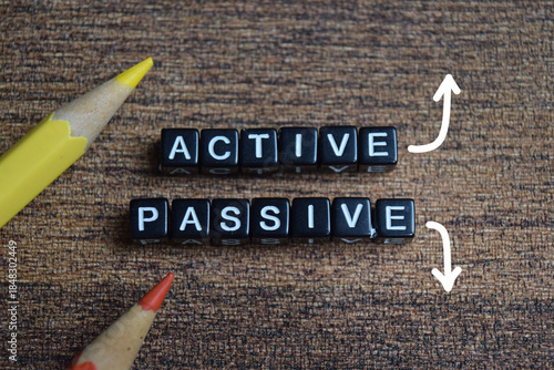 Foto Concept of active and passive income words arranged with on wooden letter blocks
