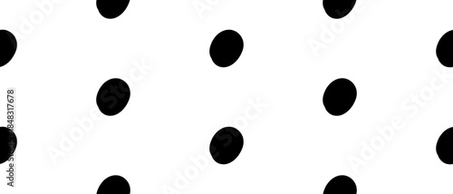 White background with bold black dots arranged in a loose grid. Seamless sprinkle pattern in minimalist hand drawn style. Vector illustration on an isolated background.
