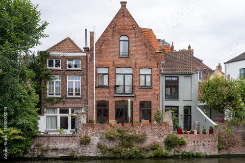 Fototapeta Scenic view of traditional brick canal houses with garden terraces in Bruges, Be