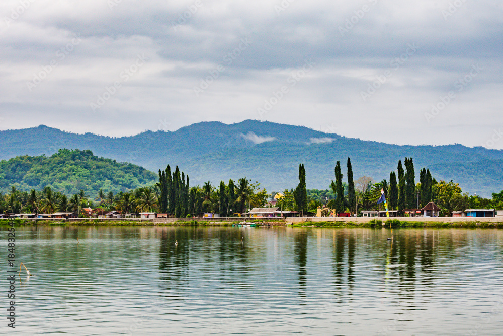 Fototapeta premium Morning atmosphere of Lake Rowo Jombor, Klaten Regency, Indonesia, Lake with a mountain background