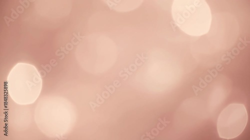 Soft Focus Bokeh Lights on a Warm Rose Gold Background. 4k Footage Video