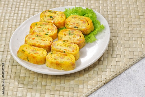 Wallpaper Mural Tamagoyaki or Gyeran mari is a rolled omelette made from seasoned beaten eggs and cooked in thin layers, then rolled repeatedly into a cylindrical or rectangular shape. Torontodigital.ca