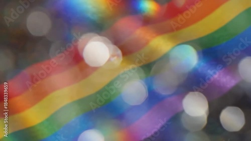 A vibrant and captivating abstract background showcases a beautiful diagonal rainbow spectrum, elegantly blurred and infused with shimmering bokeh lights and subtle, dynamic lens flares. The distinct 