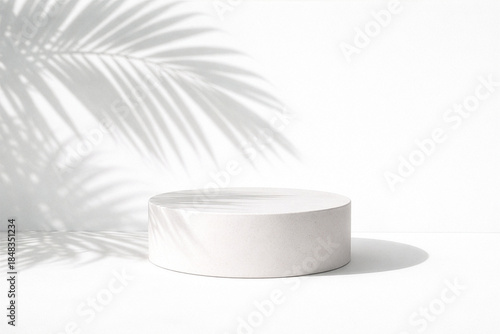 White podium with tropical leaf shadow on white background