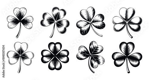 Set of black and white shamrock and four leaf clover graphics in a vintage woodcut style perfect for St Patricks Day holiday decorations and lucky charm symbols.