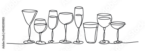 Collection of diverse drinking glasses including wine champagne and tumblers arranged in a line for celebrations and hospitality concepts