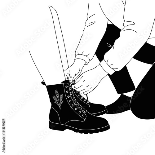 Person tying shoelaces on a black combat boot.