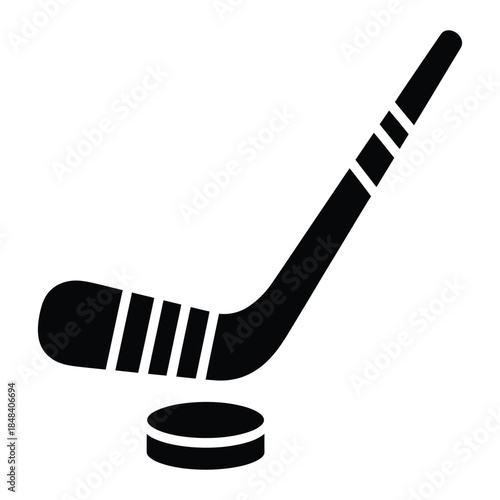 Hockey stick and puck silhouette icon