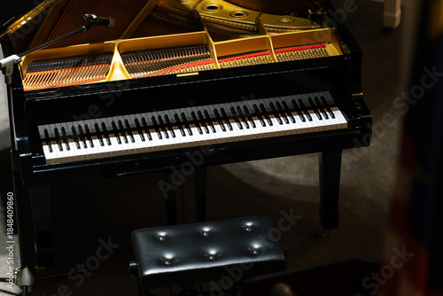 Close-up of a piano captured under dramatic lighting.