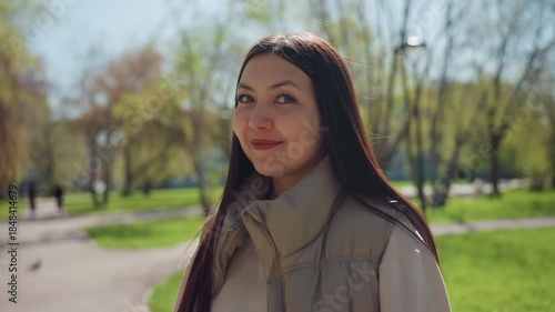 joyful outdoor greeting, cheerful female outdoors exhibiting friendly gestures on sunny day, lively woman demonstrating joyful and amicable gestures while enjoying sunlight outdoors in park