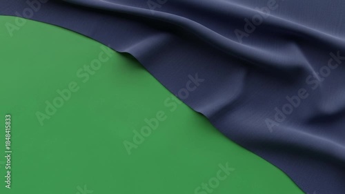Cloth on a Green Backdrop: A piece of navy cloth gracefully drapes across a vibrant green backdrop, creating a visually compelling display of texture and color contrast.