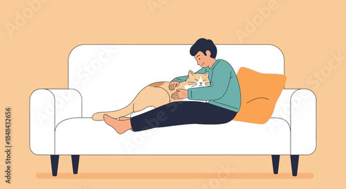 A young man sits comfortably on a white couch, gently petting his ginger cat, enjoying a moment of peaceful companionship at home