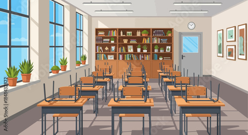 An empty classroom with rows of desks and chairs, a bookshelf filled with books, and large windows letting in natural light