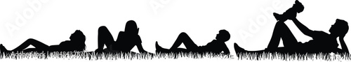 Silhouettes of people lying on grass in relaxed poses showing family bonding, leisure, and outdoor rest in nature