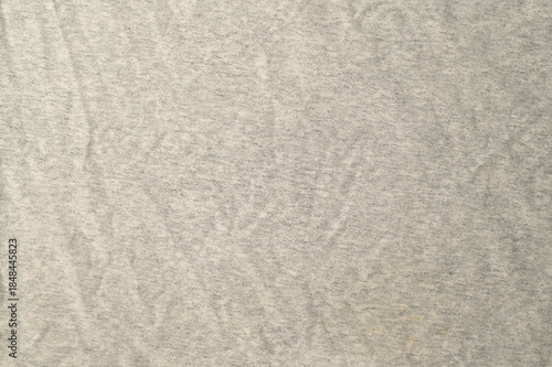 High-resolution.Top view of a light gray heathered fabric, likely a jersey knit used for t-shirts or activewear.