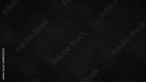 A completely black image with a slightly textured, dark background.