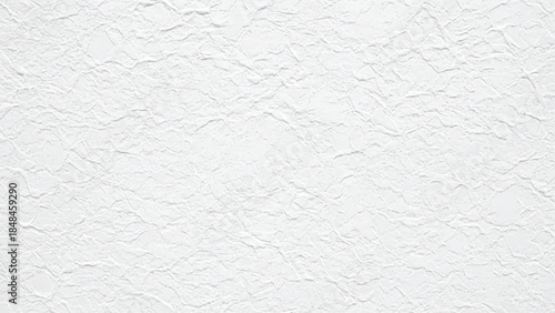 Close-up of a textured white surface resembling crumpled paper or plaster