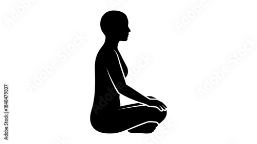 Silhouette of woman meditating in seated yoga pose