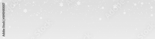 Soft winter snowfall background, white snowflakes falling on light grey gradient for banners and greeting cards