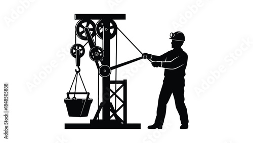 Silhouette of a worker operating a pulley system with a bucket
