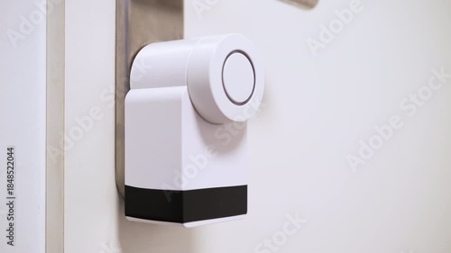 Male hand pressing a button on a smart lock to open a door, digital access technology.