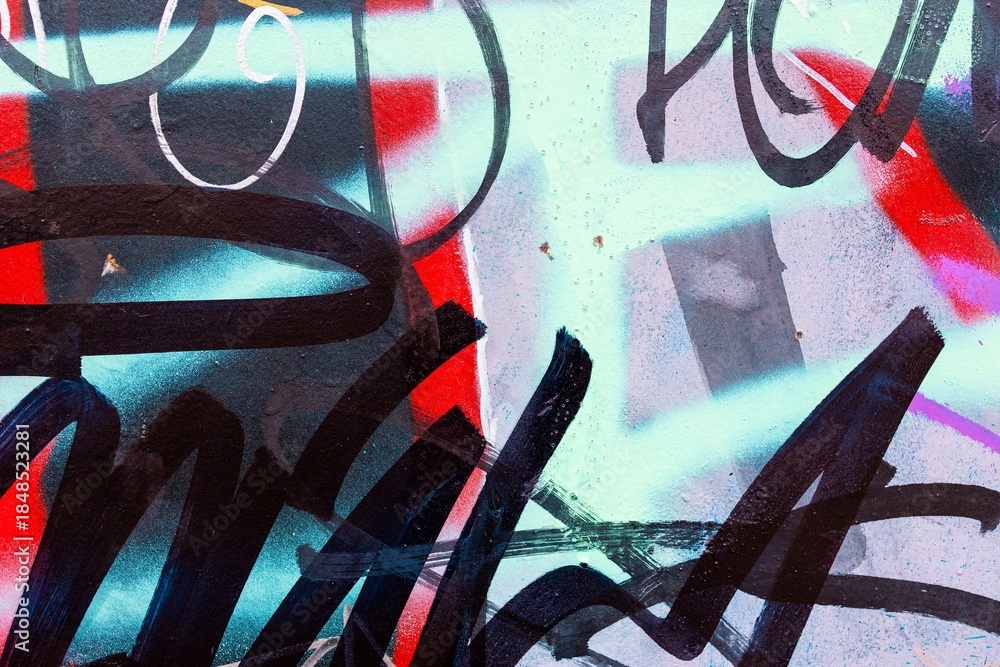 Naklejka premium Graffiti wall art with bold black, red, blue. Urban 90s style, vibrant pattern, street aesthetic. Background, texture, creative banner, modern 90s urban visuals.