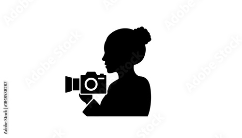 Silhouette of a woman holding a camera, capturing moments, representing photography and videography.