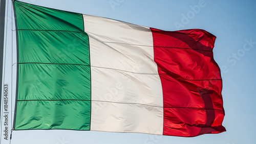 italian flag waving on flagpole against clear blue sky, vibrant colors and fabric motion
