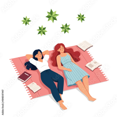 Two young women relaxing together on a pink blanket outdoors, looking up at green star shapes