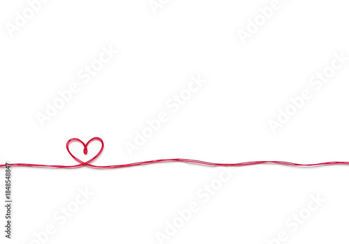 A single strand of red and white bakers twine tied into a small heart shape