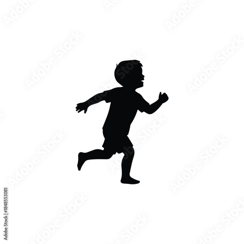 Silhouette of a young boy running and playing with excitement