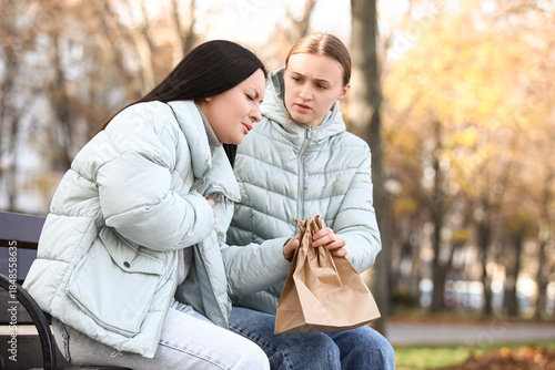 Female passer-by giving pap...