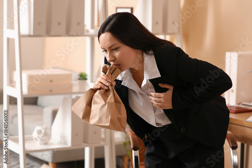Businesswoman with paper ba...