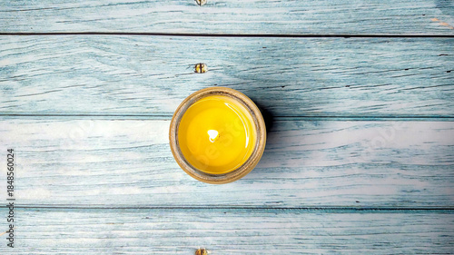 Aroma candle in a glass of natural soy wax on wooden background