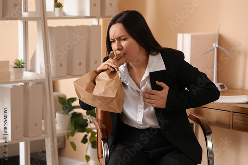 Businesswoman with paper ba...