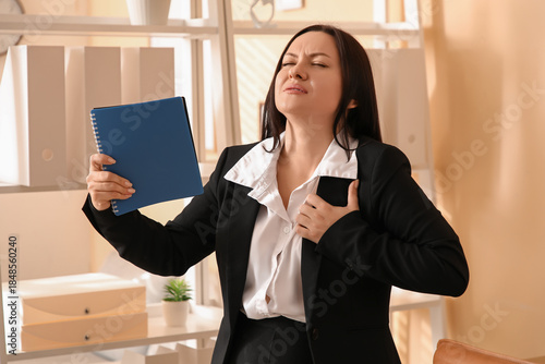 Businesswoman with notebook...