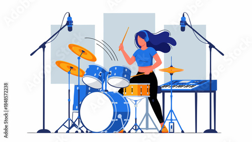A woman wearing headphones plays a blue drum set with drumsticks in a recording studio with microphones.