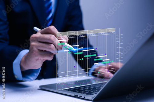 Project manager concept working with Gantt chart schedule to plan tasks and deliverables. Scheduling activities with strategic planning software organizing schedules and important dates.