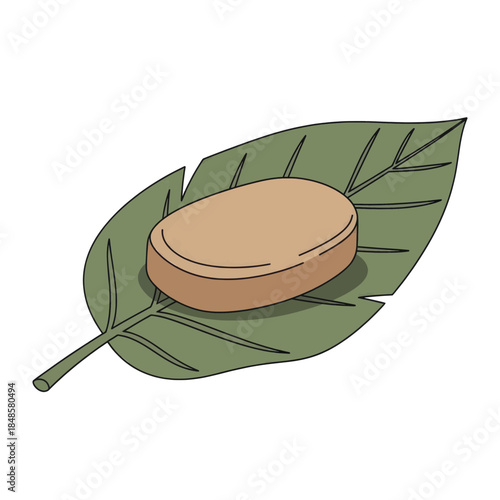 Natural soap bar resting on a leaf.