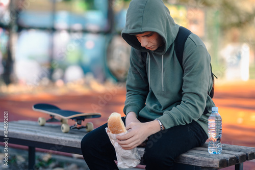 Fotografie Teenager feeling sad and lonely eating lunch alone
