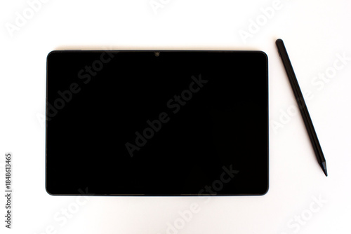 A new black digital tablet and a stylus pen isolated on white background.