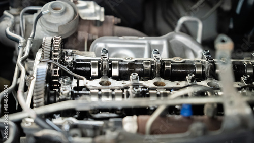 Fotografie A close up of a car engine with a lot of oil on it