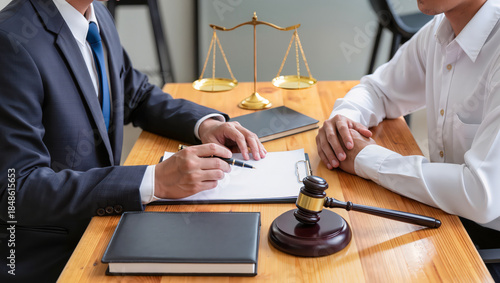 Lawyer and client discussing legal matters during a consultation meeting.